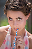 Woman Sipping Refreshing Drink With Straw, Close-Up