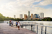 Boardwalk Along River with Skyline in Background, Austin, Texas, USA