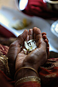 Hands Holding Flower Petals During Hindu Wedding Ceremony