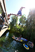 Jump from the bridge in river Alz at Truchtlaching, Chiemgau, Upper Bavaria, Bavaria, Germany