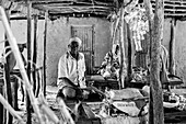 Old man sitting at a market stall in Kigamboni, Tanzania, Africa