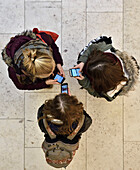 3 Girls chatting with smartphones in a shopping mall, Hamburg, Germany, Europe