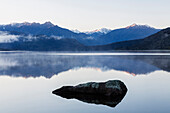 Mountains reflecting in still lake, Hokitika, South Westland, New Zealand