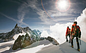 Caucasian hikers standing on snowy mountain top, Mont Blanc, Alps, France