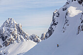 Caucasian climber scaling snowy mountain slope