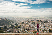 Caucasian woman admiring scenic view of cityscape, Granada, Spain