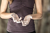 Close up of chalky hands of athlete in gym