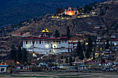 Illuminated buildings on remote hillside, Paro, Paro District, Bhutan