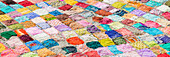 High angle view of colorful saris drying on flat ground