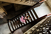 Hispanic ballet dancer posing on staircase