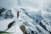 Caucasian hiker cheering on snowy mountain, Chamonix, Haute-Savoie, France