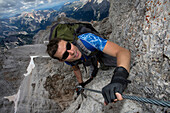 Caucasian climber scaling remote mountain slope