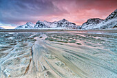 Sunset on the surreal Skagsanden beach surrounded by snow covered mountains, Flakstad, Lofoten Islands, Arctic, Norway, Scandinavia,  Europe