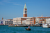 Gondola and gondolier on San Marco Basin, with Palazzo Ducale, San Marco Campanile, and Danieli Hotel in the background, Venice, UNESCO World Heritage Site, Veneto, Italy, Europe
