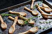 Parmesan Spoons with Rosemary on Baking Sheet