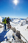 Two men standig on the peak of Cima Groste, ski touring, Brenta Dolomites, Trentino, Italy