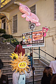 dressed up man holding advertising for a restaurant in old town of Macao, China, Asia