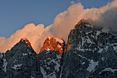 Alpenglow on the peaks of Prisojnik mountain range with clouds at sunset, Prisanc, seen from Krnica hut (Dom Krnica), Sava Valley, Vrsi-Pass, Triglav National Park, Julian Alps, Slovenia, Europe