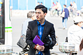 Young handsome man on street, waiting for bus, earring, black jacket, blue shirt, Shanghai, China, Asia
