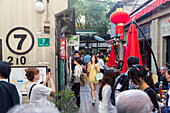 Young women, Tianzifang, arts and crafts area, visitors on street, shops, red lanterns, shopping street, French Concession area, Shanghai, China, Asia