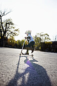 Young boy riding a 2-wheeled scooter, Montreal, Quebec, Canada