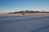 4X4 Vehicle In The Salar De Uyuni, The World's Largest Salt Flat At Sunrise, Potosi Department, Bolivia