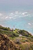 View of Diamond Head Lighthouse with waves breaking in the shallow water in background, Honolulu, Oahu, Hawaii, United States of America