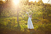 Caucasian girl tossing flower petals outdoors