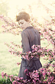 Woman standing in flowering trees