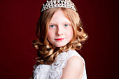Caucasian girl wearing tiara and princess costume
