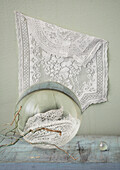 Lace hanging over crystal balls and branches on table