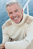Close up of smiling Caucasian man on boat deck