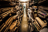 Stacks of old newspapers in library archive