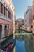 Gondola sailing in Venice canal, Veneto, Italy
