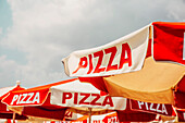 Low angle view of pizza on umbrellas outdoors