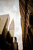 Low angle view of high rise buildings under cloudy sky, New York City, New York, United States