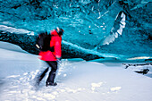 Blurred view of hiker walking in ice cave