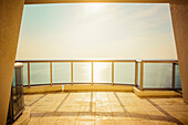 Balcony overlooking ocean and sunny sky