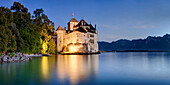 Panorama of the fortress Chillon at the shore of Lake Geneva in blue dawn, Montreux, Canton de Vaud, Switzerland