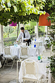 waiter setting the tables, lago di Garda, Trentino, South Tyrol, Italy