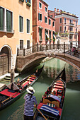 Gondola passing under a bridge over a small canal, Venice, UNESCO World Heritage Site, Veneto, Italy, Europe
