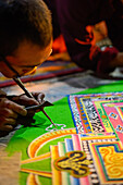 Buddhist monchs preparing a sand mandala with coloured wheat flour. The ceremony lasts for several days. Only very few visitors are granted entrance to this very seldom ceremony. Even less are allowed to take photographs. Lo Manthang (3840 m), former capi