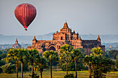 Hot air balloon flying over temple