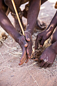 Himba men lighting a fire, North Namibia, Namibia, Africa