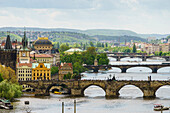 Prague cityscape looking down the Vltava River at its bridges connecting the Old Town to Mala Strana, Prague Castle and Hradcany, Prague, Czech Republic, Europe