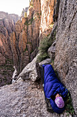 Woman camping on ledge in the Black Canyon of the Gunnison, Montrose, Colorado.
