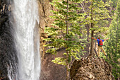 A man hiking below Treasure Falls, San Juan National Forest, Pagosa Springs, Colorado.