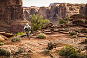 A man mountain biking on the Hymasa trail, Moab, Utah.