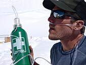 Physician of Denali Rescue is testing an emergency oxygen system, high on Mt. McKinley. With this system patients can be administered low concentration of oxygen, that will help them recover from altitude sickness, when descending the mountain.