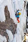 A man ice climbing a frozen waterfall in the Ouray Ice Park, Ouray, Colorado.